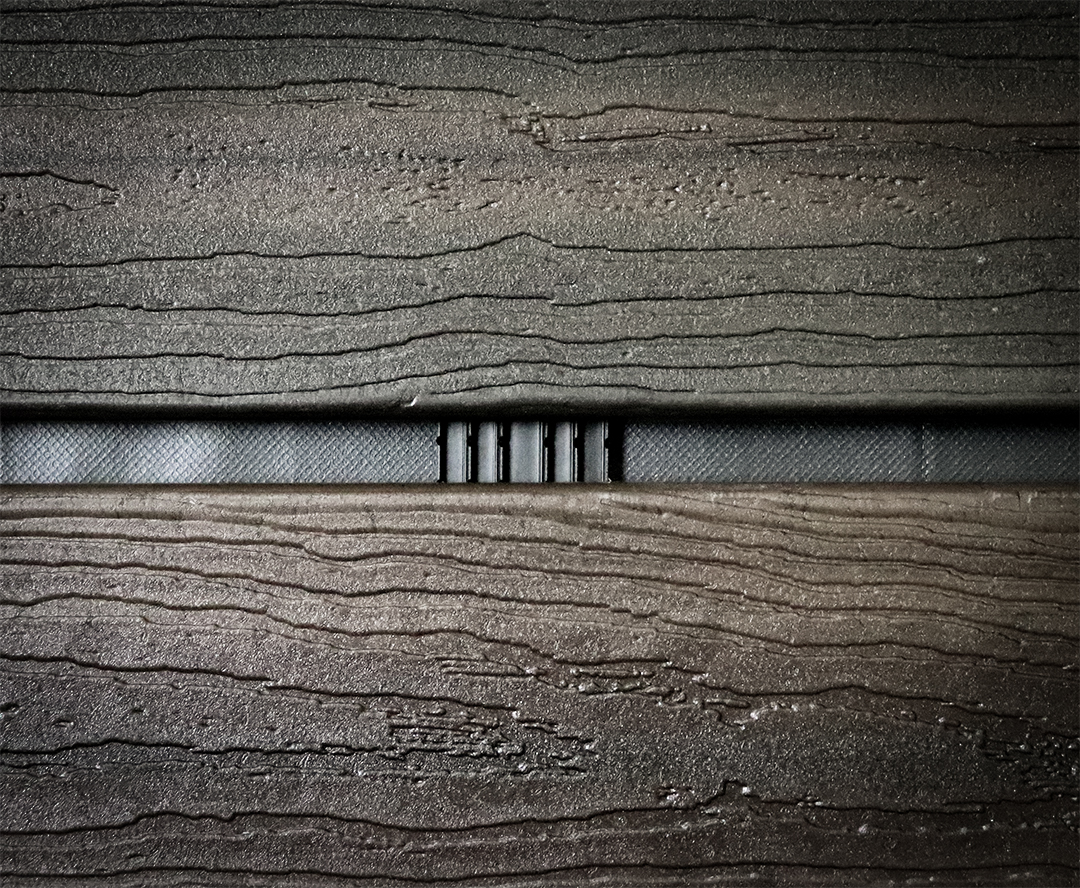 Close up of a Batten UV strip installed behind wood open joint cladding