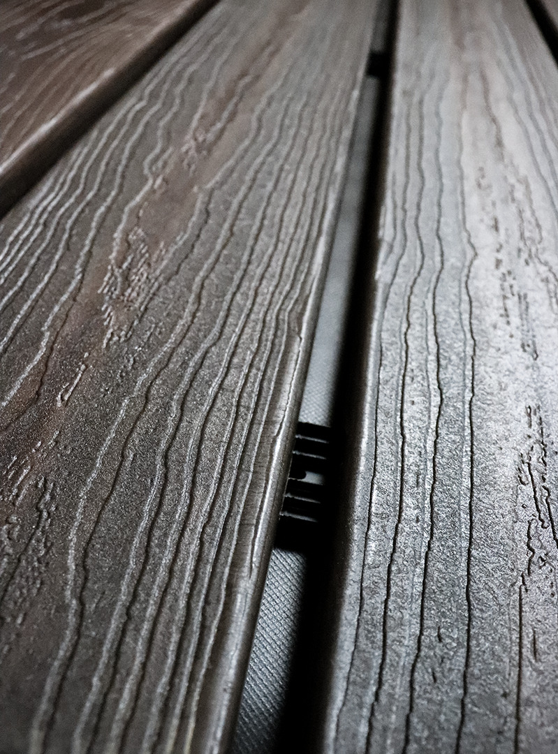 A Batten UV strip installed between the space of wood open joint cladding